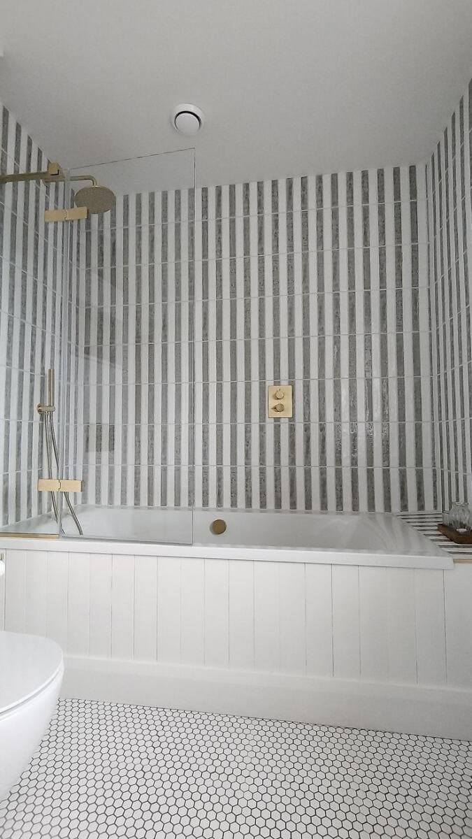 striped vertical tile in shower black and white